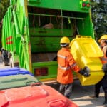two workers collecting garbage of urban municipal are collecting for trash removal. garbage collector.