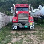 red truck parked along concrete fence